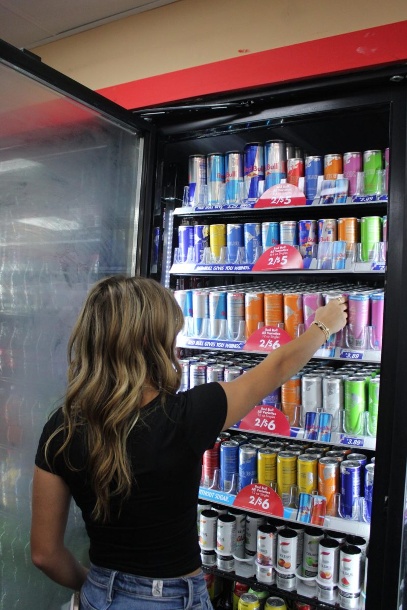 Senior Sophie Carter reaches for her favorite energy drink before school. 