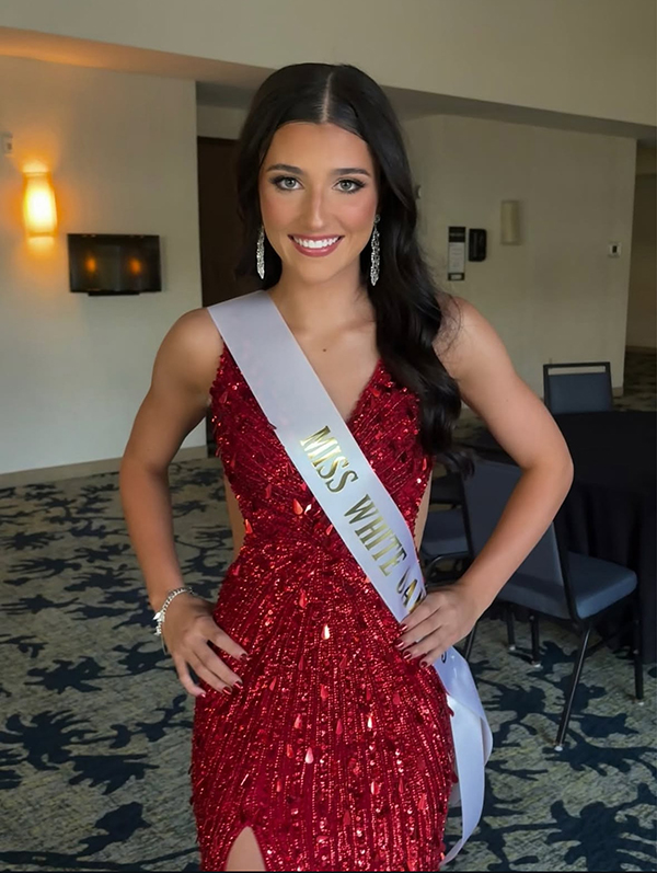 Waiting to take the stage at the Miss Gregg County Pageant, junior Kylie Caraway poses for a picture backstage.