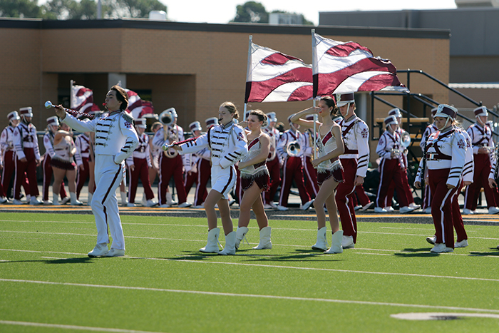 Senior drum major Shawn Richardson and senior assistant drum major Stephanie Wilson lead the band onto the field.
