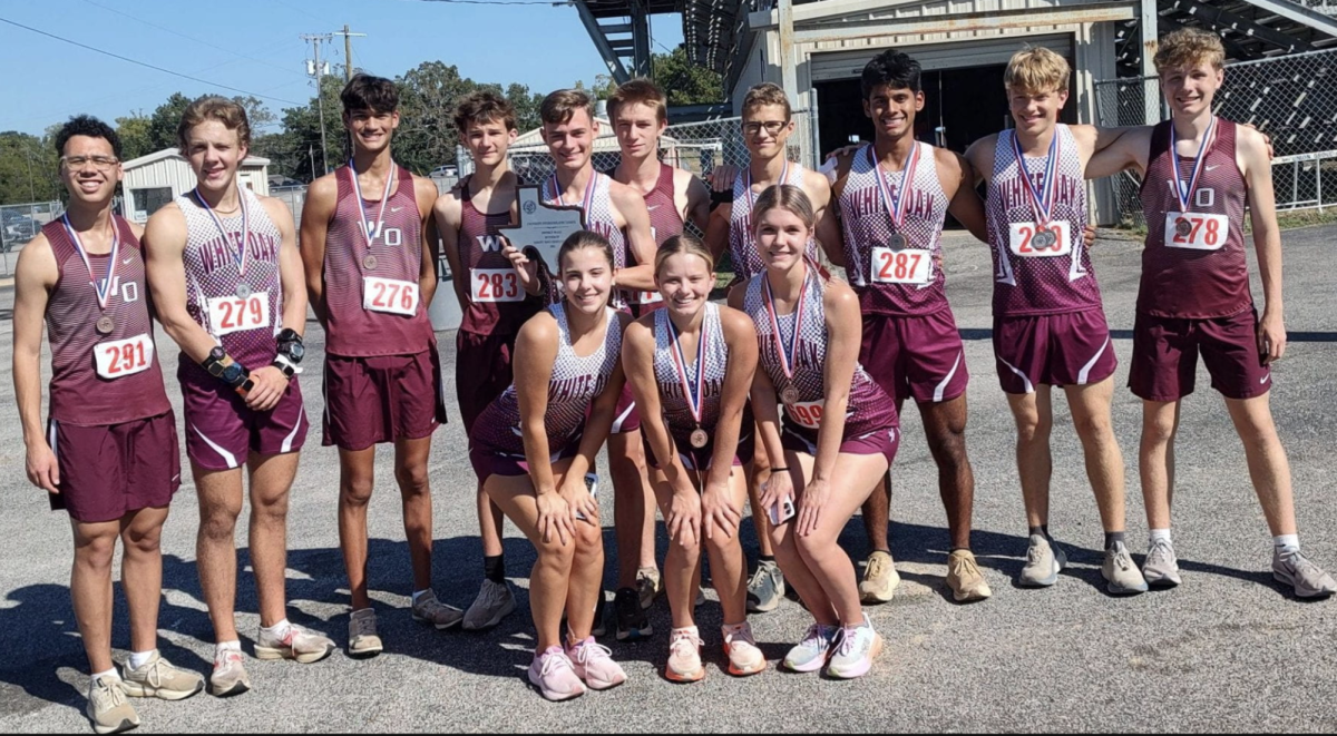 The cross country team gathers after district competition.